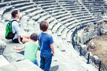 Mother With Little Sons On Vacation Visiting Ancient Colosseum, Summer Tourism, Lifestyle People Concept