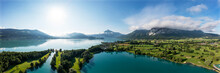 Drone Panorama Of Sun Shining Over Golf Course On Shore Of Mondsee Lake