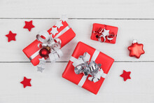 Wrapped Presents And Star Shaped Christmas Decorations Flat Laid On White Wooden Surface
