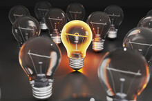 Three Dimensional Render Of Single Glowing Light Bulb Standing Amid Other Light Bulbs