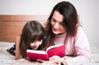 © gmstockstudio - Mom with the daughter reading together