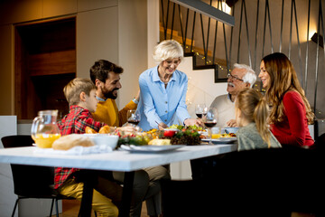 Wall Mural - Happy family having dinner with red wine at home