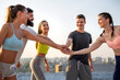 Group of happy fit people friends exercising together outdoor