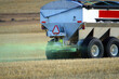 Agriculture spreading fertilizer on field 