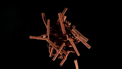 Poster - Super slow motion of rotating cinnamon barks on black background. Ultimate realistic rotating motion. Filmed on high speed cinema camera, 1000fps.