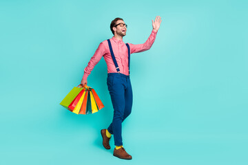 Sticker - Photo of sweet charming gentleman wear pink shirt glasses holding bargains waving arm empty space isolated teal color background