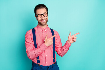 Photo of young cheerful man happy positive smile point fingers empty space advert suggest sale isolated over teal color background