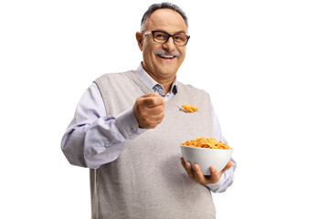 Canvas Print - Smiling mature man standing and eating cornflakes