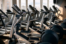 Interior Of The Modern Gym With Large Windows. Elliptical Trainers Orbiter And Treadmills.