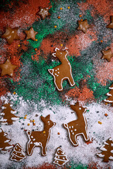 Wall Mural - Gingerbread Christmas Cookies in christmas background with candles and pine branches