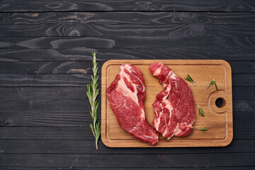 Wall Mural - meat steak wooden board and spices ingredients top view