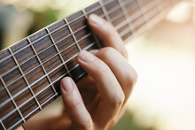 Close-up Of Hands Playing Guitar