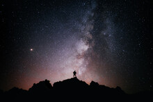 A Person Standing Looking At The Star Field And The Milky Way