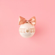Gentle White New Year Tree Ornament With A Pink Bow On Pink Background