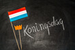 Hyacinths and paper Netherlands on chalkboard background. Koningsdag or Kings Day is a national holiday in the Kingdom of the Netherlands.