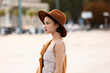 Leinwandbild Motiv Young fashionable woman in felt hat on city street
