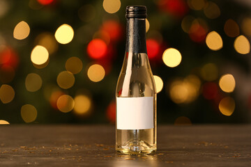 Bottle of champagne on table against blurred background