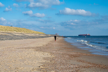 view on white sandy beach, dunes and water of north sea between vlissingen en domburg, zeeland, neth