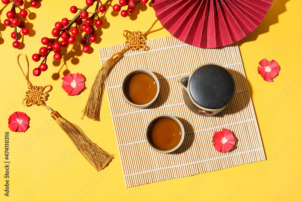 Composition with traditional Chinese tea and decor on color background