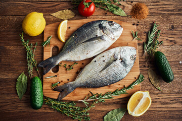 Wall Mural - sea fish fresh ingredients lemon on wooden board