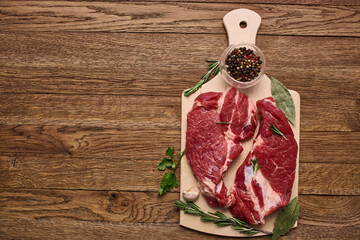 Wall Mural - meat on a wooden table pepper ingredients cooking protein