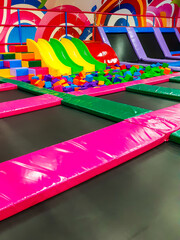 Wall Mural - Kids trampoline and soft cubes in children playground indoor