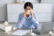 Unhappy young hindu female manager, blows nose in napkin, suffers from headache and cold