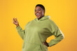 Joyful Overweight Black Woman Snapping Fingers Over Standing Yellow Background