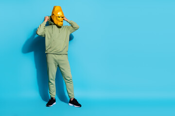 Sticker - Photo of serious wacky man wear monkey mask adjusting putting on hood empty space isolated blue color background