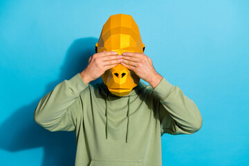 Wall Mural - Photo of scared upset guy dressed wild animal mask arms cover eyes isolated blue color background