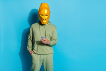 Photo Of Wacky Serious Man Wear Monkey Mask Chatting Modern Gadget Empty Space Isolated Blue Color Background