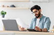 © Prostock-studio - Expensive modern life. Disappointed arab man calculating taxes or planning budget while sitting at kitchen table