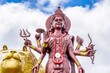 A powerful Statue of the Hindu goddess Durga Maa with a golden lion in sacred Ganga Talao. Grand bassin crater lake, Mauritius island. High quality photo. High quality photo