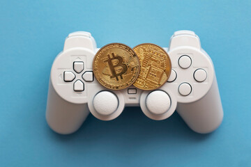 Wall Mural - Crypto gaming concept. Video game controller with a bitcoin cryptocurrency coin