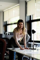 Wall Mural - Young businesswoman in office organizing documents.