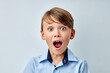 © alfa27 - caucasian little boy amazed by news with opened mouth isolated gray color background. Cute young boy in shock, looking at camera in disbelief. Shock, amazement, surprise concept.