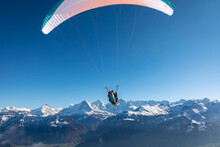 Paraglider In The Bernese Alps.In The Background Mountain Peaks Of Eiger, Moench And Jungfrau, Switzerland