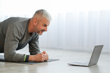 Closeup of senior man having online fitness class
