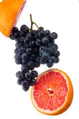 Wall Mural - Dark blue grape with red grapefruit isolated on white background