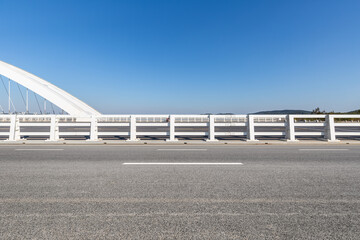 Canvas Print - asphalt road surface with modern bridge