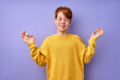 © alfa27 - Portrait of young teenage boy keep calm, meditating, isolated on purple studio background. Kid in yellow casual shirt standing with eyes closed engaged in yoga, focused on thoughts, smiling