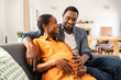 © Rido - Happy loving pregnant black couple expecting baby