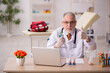 © Elnur - Old male doctor pharmacist working in the clinic