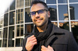 © ADDICTIVE STOCK - Positive male wearing eyeglasses on street
