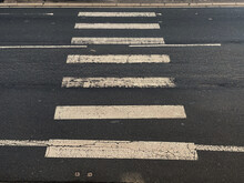 Pedestrian Crossing Marked On The Road With Black And White Paint - Zebra Crossing For People In Busy Road