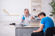 © Elnur - Young male patient visiting old male doctor gastroenterologist
