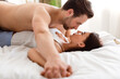 © Prostock-studio - Couple Lying In Bed Holding Hands Having Sex In Bedroom