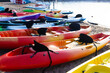 © Shi  - Colorful plactic kayaks or canoe on the beach sand for tourist rent. Surfing boards on stand during summer season