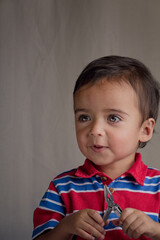 portrait of little boy using pliers