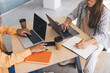 © BullRun - Businesswomen working at desk in business office